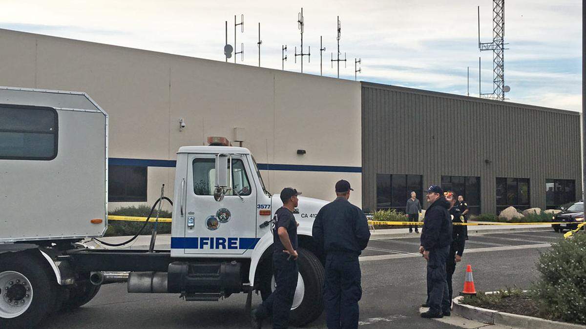 Firefighters stand by Monday afternoon outside the Santa Maria police station after a man brought an envelope containing a white powder to the station.