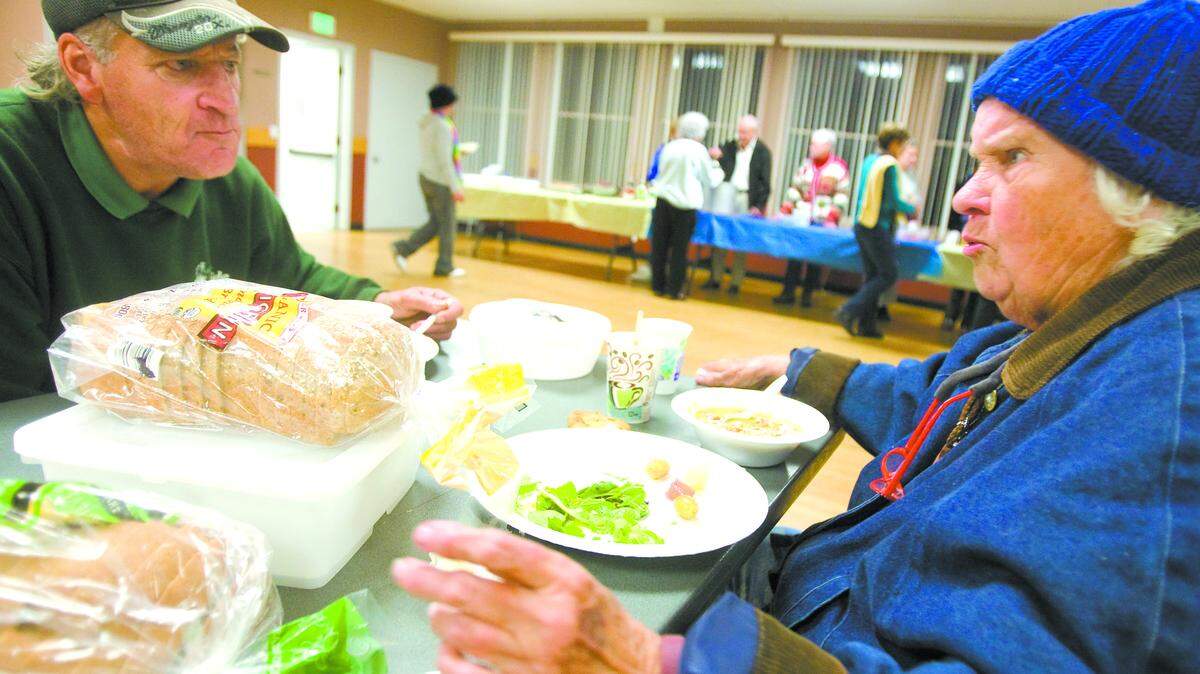 Thomas Buehler and June Viviani share a meal at the Morro Bay veterans hall. Dinner was split pea soup, fruit salad, green salad, bread and various desserts. Estero Alliance for Care hosts a weekly dinner for the homeless and needy at the hall.