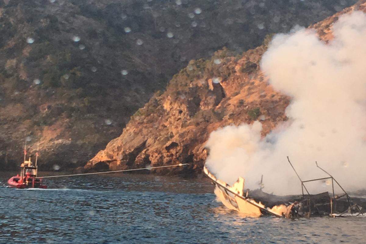 TowBoat US Ventura pulls the sinking Conception closer to shore in an attempt to keep the wreckage in shallower water, making it easier for divers to locate and recover the bodies of victims. 