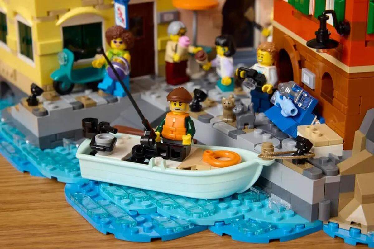 Alex Sahli, a third-year computer science student at Cal Poly, designed an Italy-inspired Lego set through the Lego Ideas program. He’s featured in the middle of a seaside village scene, holding his camera.