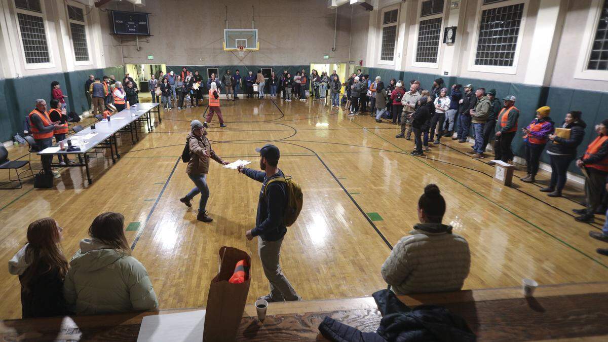 Volunteers making the Point-In-Time Count of unhoused were out before dawn on Jan. 27, 2026. Here one group gathered for instructions at the Ludwick Community Center before heading to assigned areas .