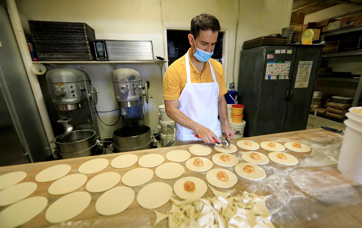 Dante Garcia makes the fruit-filled fried pies at Carlock’s Bakery in Los Osos.