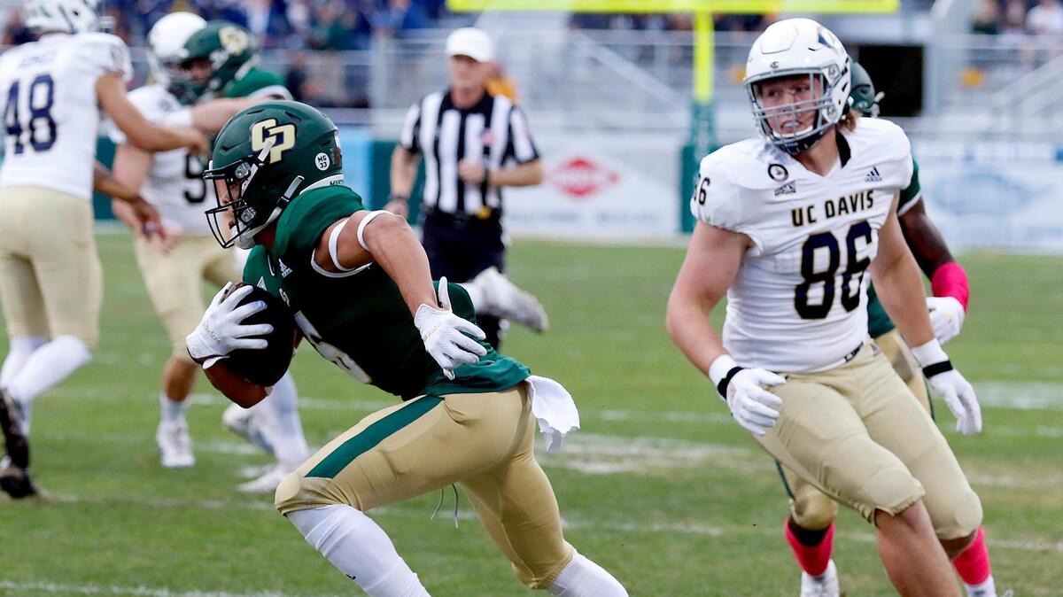 Cal Poly’s Chris Coleman (6) averts a tackle by UC Davis’ Evan Bearden (86). Cal Poly lost to UC Davis 24-13 at Alex G. Spanos Stadium, Saturday, Oct. 23, 2021, in San Luis Obispo.