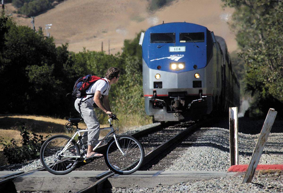 This file photo shows a bicyclist crosses the railroad tracks at the unguarded crossing near Cal Poly’s Mustang Stadium. The situation hasn’t changed.