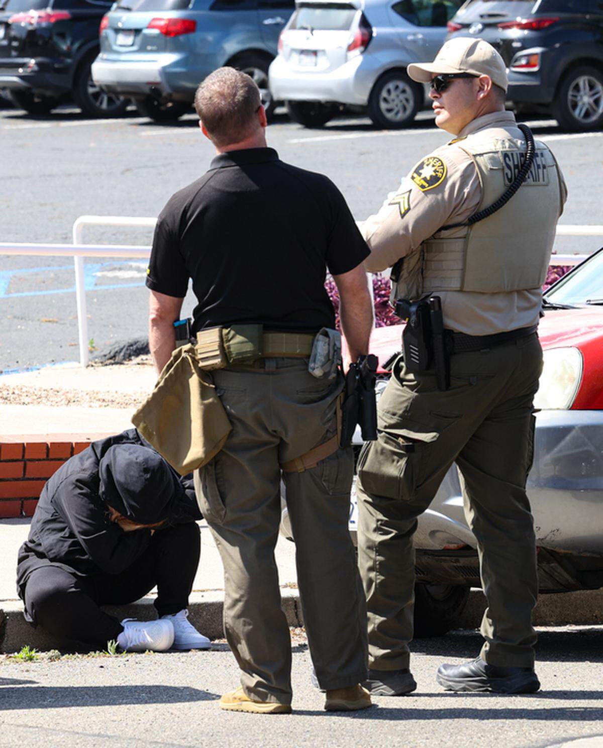 Law enforcement officers talk to a person on Sydney Street in San Luis Obispo on May 18, 2023, after a police pursuit that started in Atascadero related to a previous robbery call ended with at least one arrest and others being questioned.