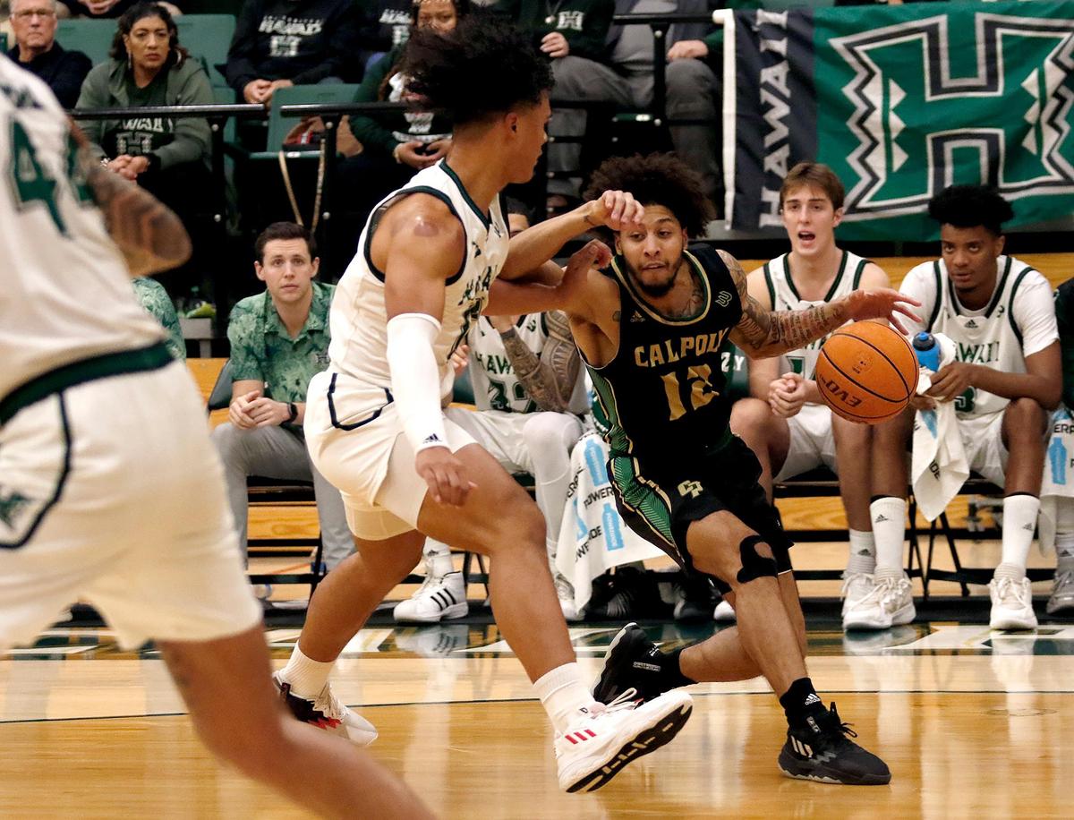 Nick Fleming (12) is blocked by Hawaii’s Beon Riley (10) in a game on Feb. 4, 2023. Fleming had 16 points in Cal Poly’s Big West tournament win over Long Beach State on Tuesday.