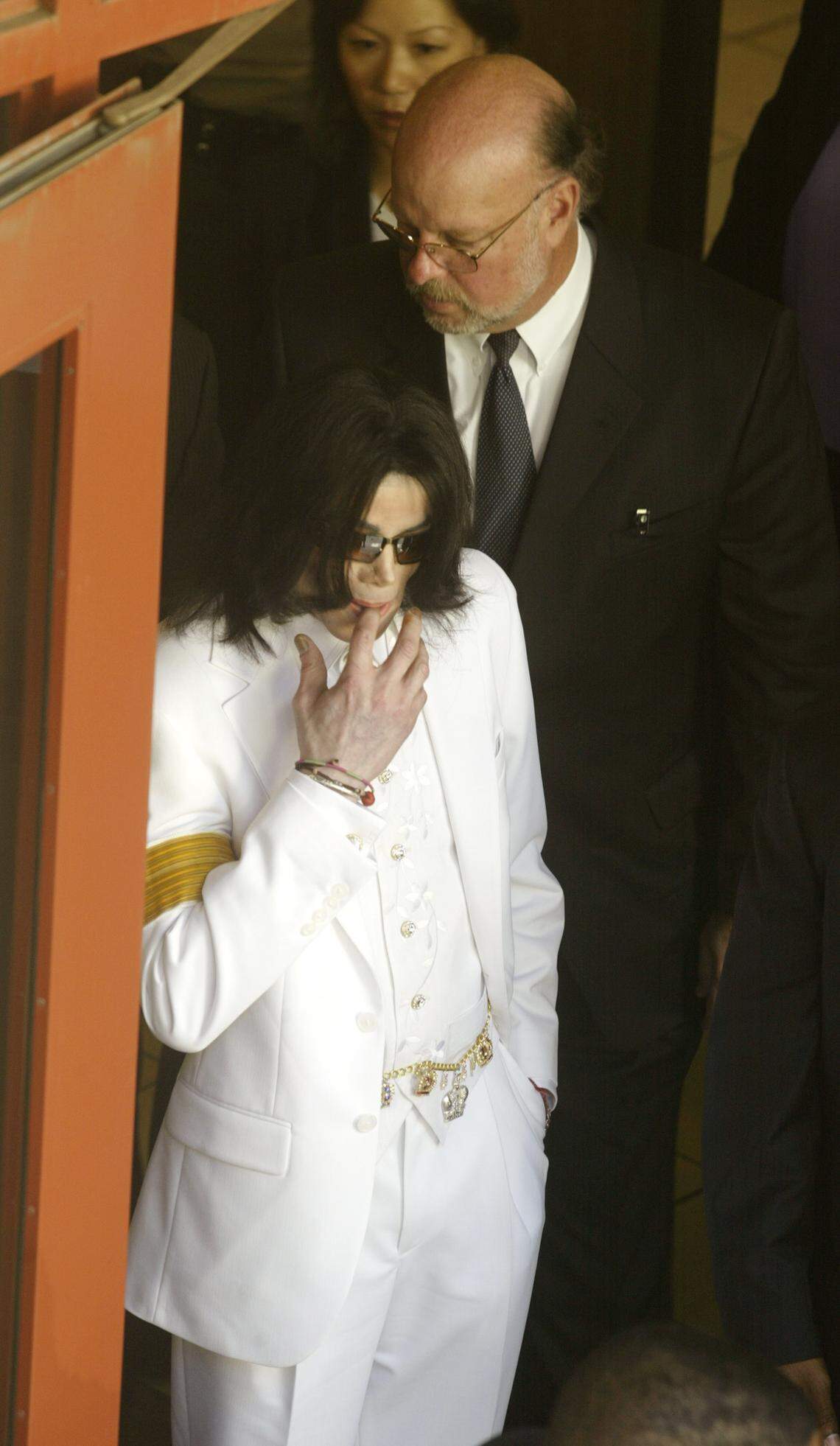 Pop star Michael Jackson prepares to depart the Santa Barbara County courthouse Monday, Jan. 31, 2005, for a lunch break during the first day of jury selection in his child molestation trial in Santa Maria, Calif. Defense attorneys Robert M. Sanger and Susan Yu follow Jackson.
