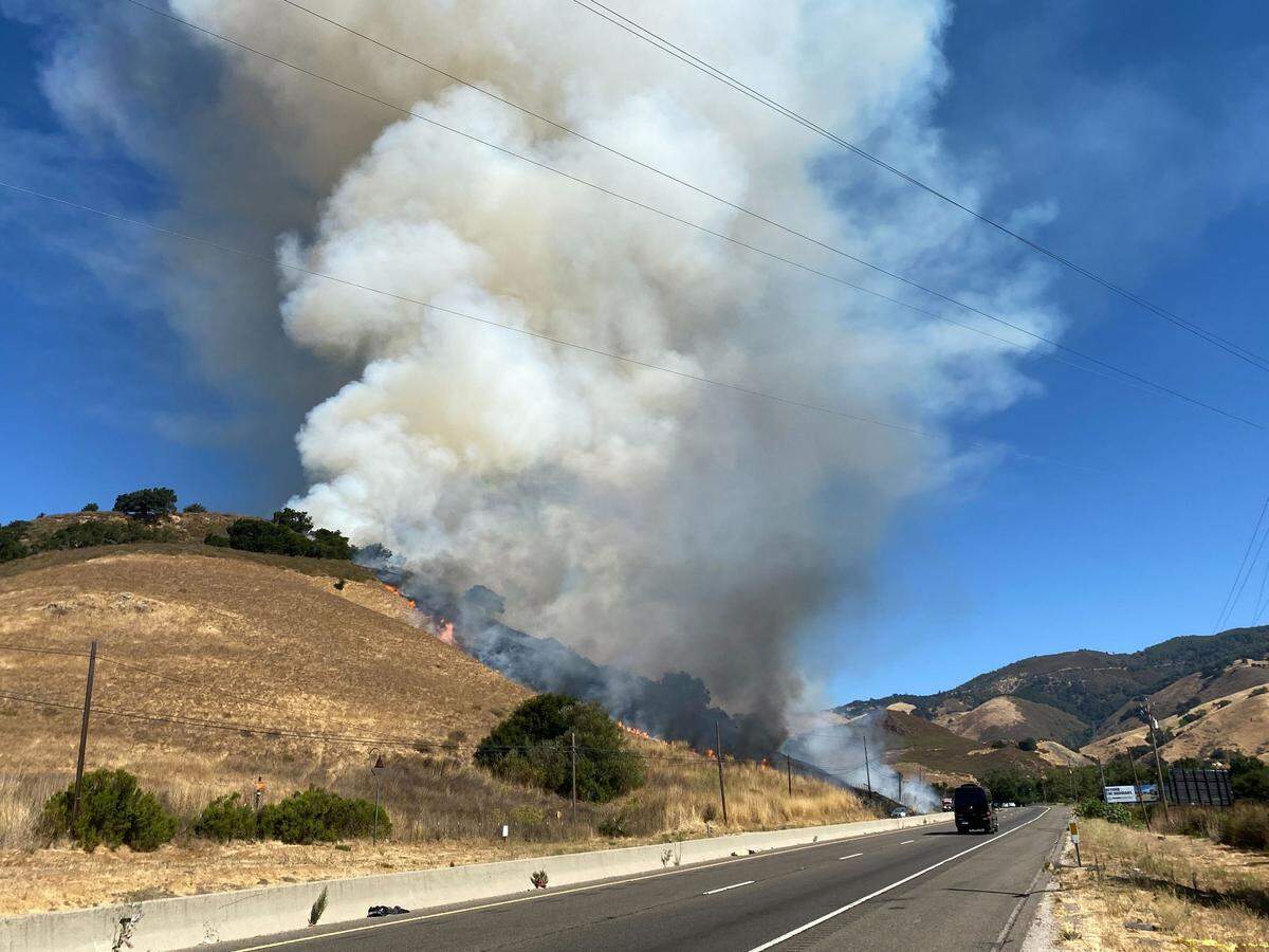A vegetation fire burns on a hill on the southbound side of Highway 101 and Hawk Hill Lane at the base of the Cuesta Grade in San Luis Obispo on Sept. 3, 2024.