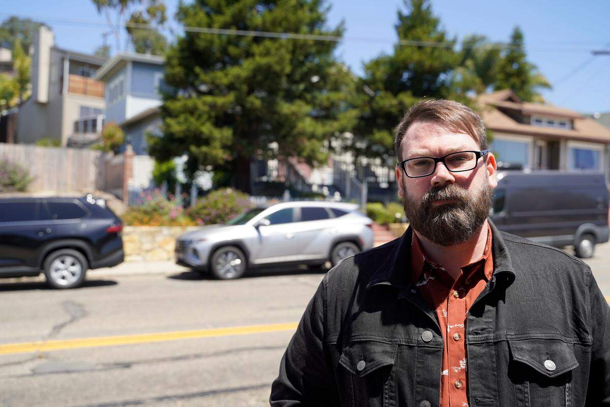 “Your Own Backyard” podcaster Chris Lambert watches as investigators search the Arroyo Grande home of Susan Flores, mother of convicted killer Paul Flores, for new evidence in the Kristin Smart case, on Wednesday, May 6, 2026.
