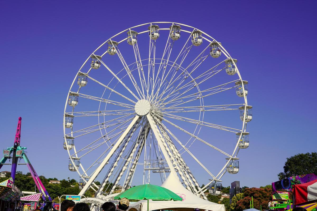 The Ferris wheel towers above the ride section of the California Mid-State Fair on Wednesday, July 16, 2025. The Mid-State Fair will run from July 16-27.