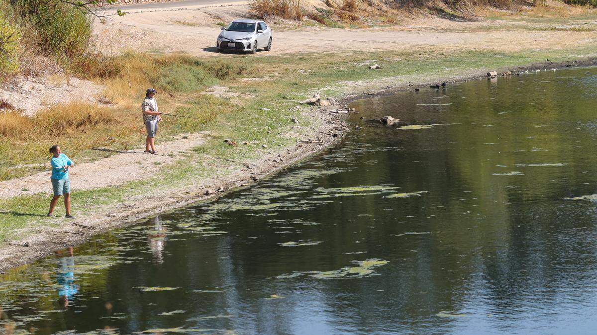 Heather Tucker and son Kyan were fishing at Atascadero Lake in September from a spot that would be under water in wet years. SLO County experienced one of its hottest Novembers this year.
