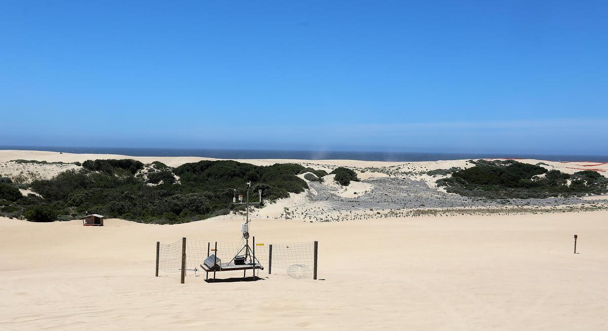 Air quality measurement instruments stand near a re-vegetation area at the Oceano Dunes State Vehicular Recreation Area.