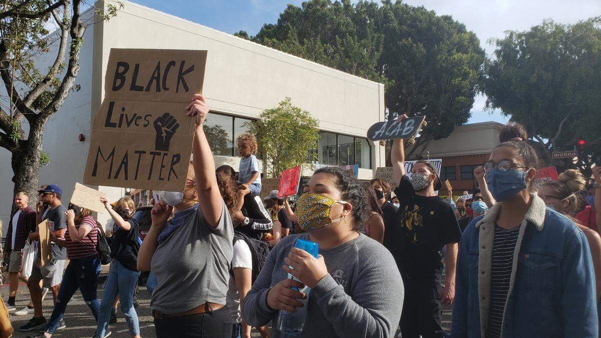Protesters march on Higuera Street in downtown San Luis Obispo on Monday, June 1, 2020.