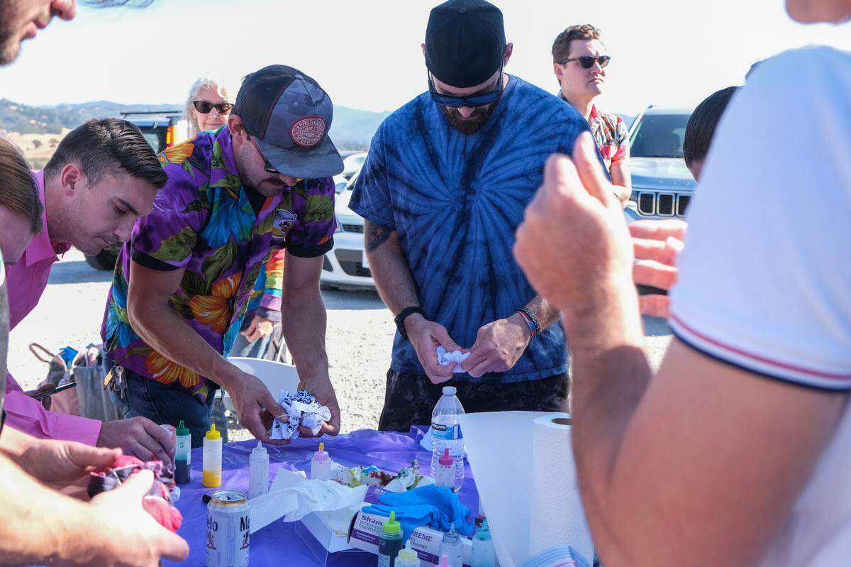 Loved ones of Todd Pinion make tie-dye shirts and bandannas at his memorial in Santa Margarita on Nov. 9, 2024. Pinion was killed in an alleged hate crime on Oct. 23, 2024.