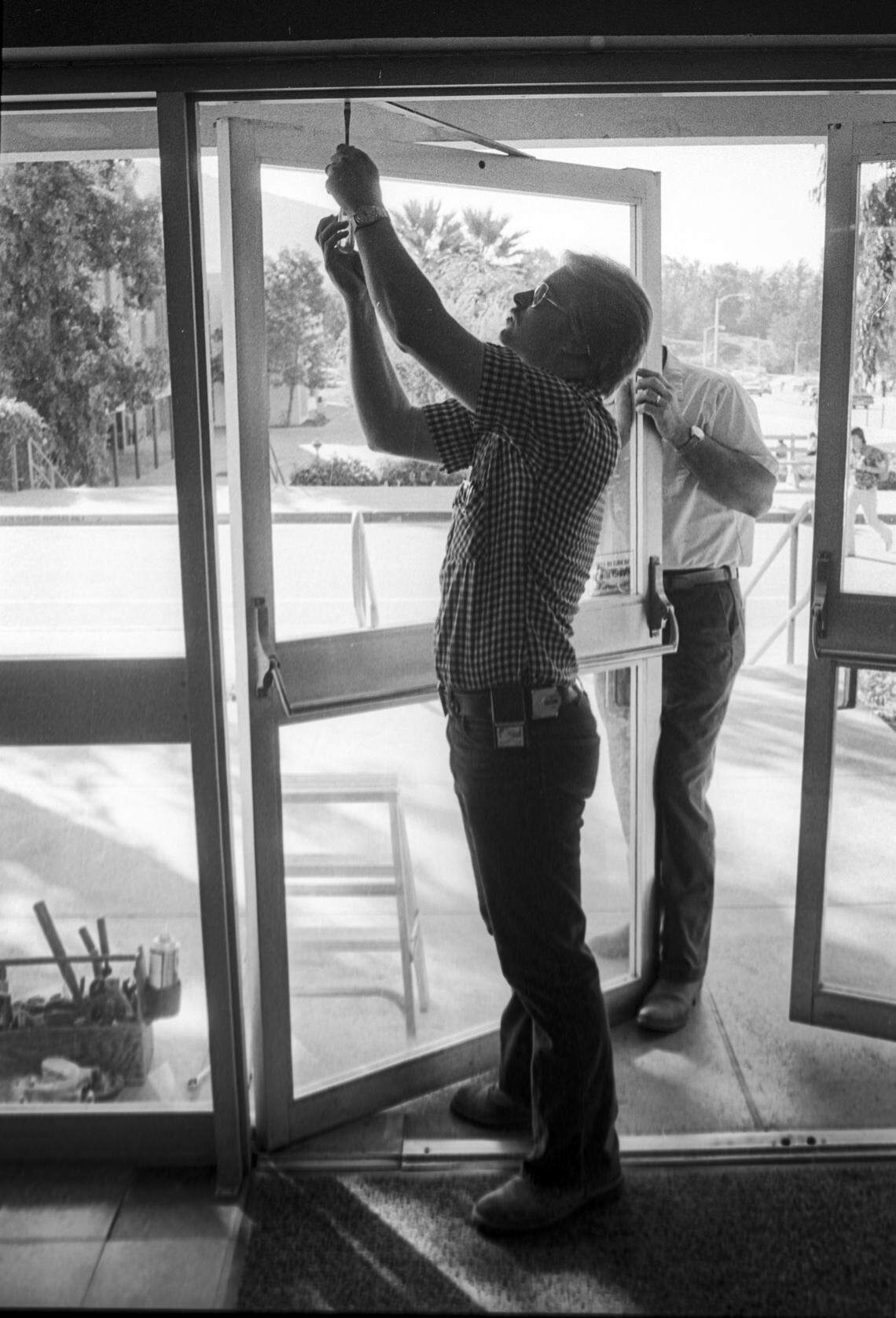 Mike Walsh installs a rebuilt door at the Cal Poly music building on Nov. 15, 1978.