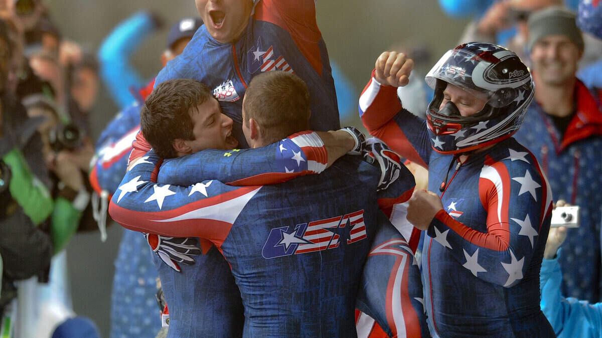 The U.S. team celebrates after driver Steven Holcomb (right) guided the four-man bobsled to a first-place finish. (Clem Murray/Philadelphia Inquirer/MCT)