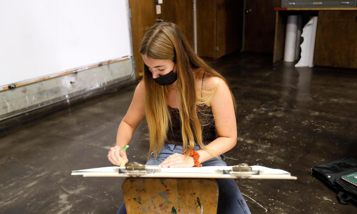 Cuesta College holds its first day of class for beginning art during the coronavirus pandemic. Sage Whitham, Arroyo Grande, a student in David Prochaka’s art class, wears a mask and practices social distancing while she concentrates on a drawing.