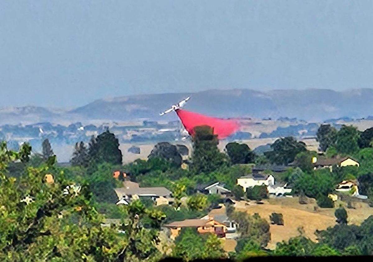 An air tanker makes a retardant drop as crews battle a vegetation fire east of Paso Robles on Wednesday evening.