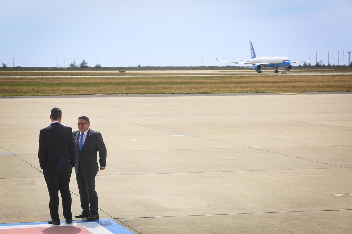 U.S. Senator Alex Padilla left and Representative Salud Carbajal share a story as Air Force 2 taxies to parking spot at Vandenberg.