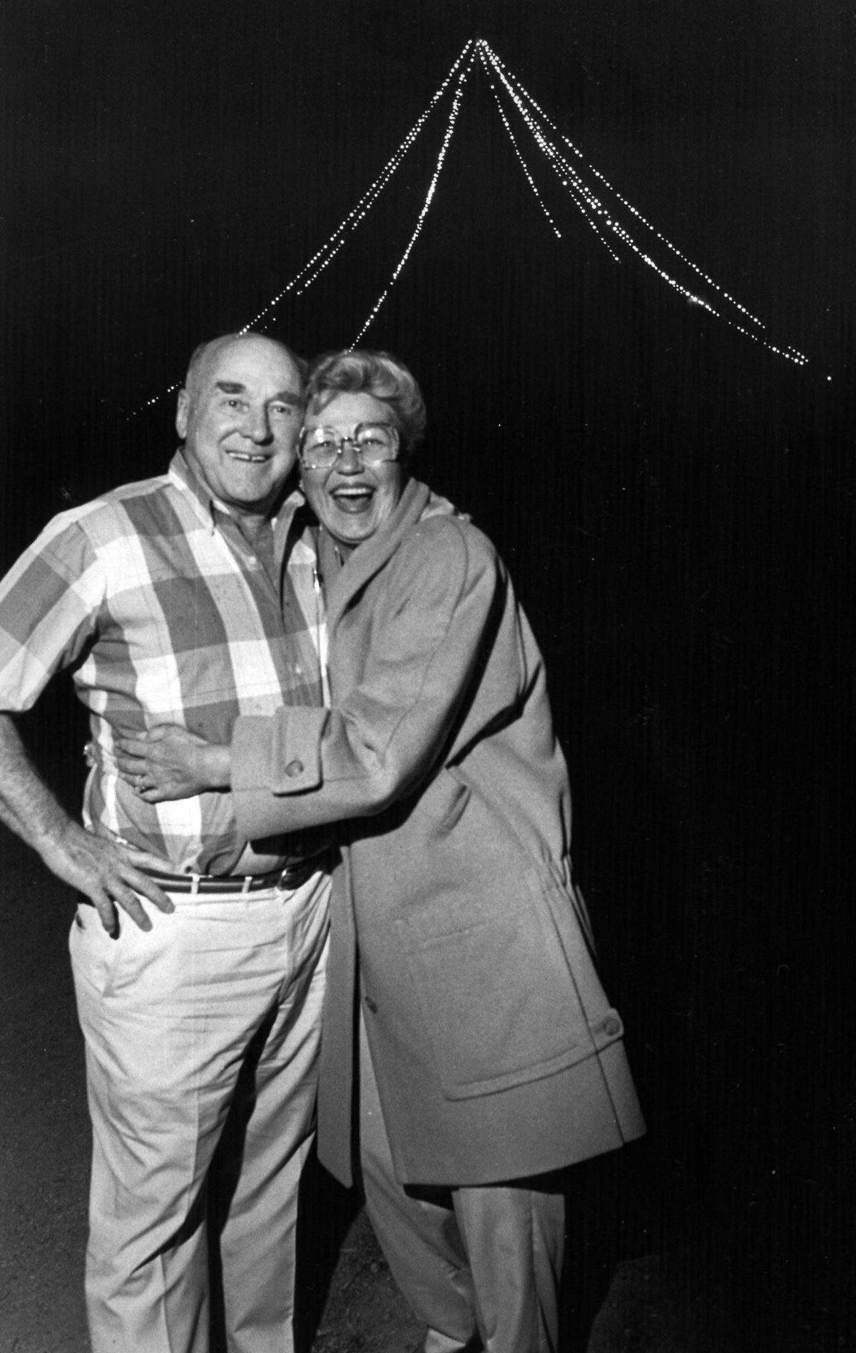 Alex and Phyllis Madonna stand at the top of San Luis Obispo Mountain in Dec. 1986 near the Christmas tree they relit this yule season after an absence of many years. The tree lighting started out to be a one day surprise birthday present from Phyllis to Alex, but they decided to keep it lit throughout the holiday season. Although there have been a few complaints and some vandalism to the lighted tree they have received numerous letters thanking them for relighting the mountaintop ornament. The Madonnas think of the tree as their Christmas card to the community. Tony Hertz/Telegram-Tribune first published 12-24-1986