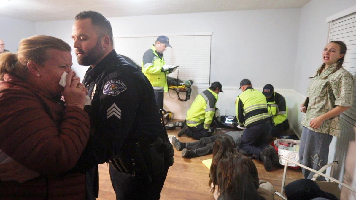 From the left, Rochelle Hanson-Torres, Sgt. Chris Hester, Alex Gentilly, Kaden Groseclose, Kayleigh Luna, Tom Birkenfeld, Andrew Luera and Lucy Peterson participate in a staged overdose scene, part of a drug abuse prevention event sponsored by Lighthouse Atascadero on Feb 24, 2025.