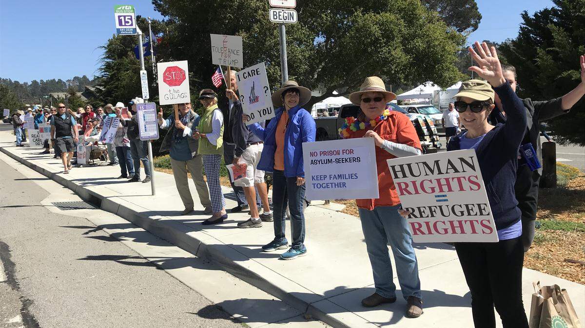 Protesters demonstrate Friday at Cambria's Farmers Market in opposition to the U.S. government's "zero-tolerance" policy.