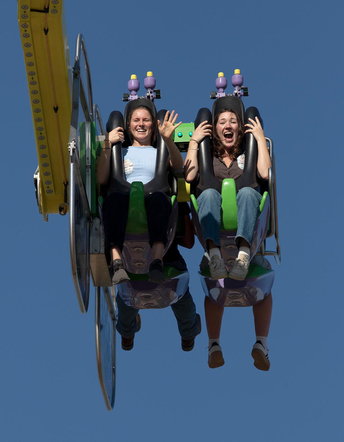 Tribune reporters Chloe Shrager, right, and Kelsey Oliver ride the Medusa at the Mid-State Fair on Wednesday, July 17, 2024.