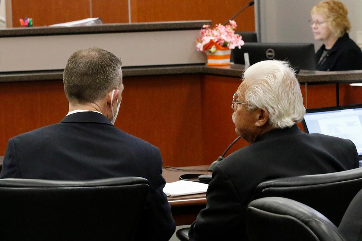 Paul Flores, left, and Ruben Flores talk in Monterey County Superior Court before court proceedings start in the Kristin Smart murder trial on Thursday, Aug. 4, 2022.
