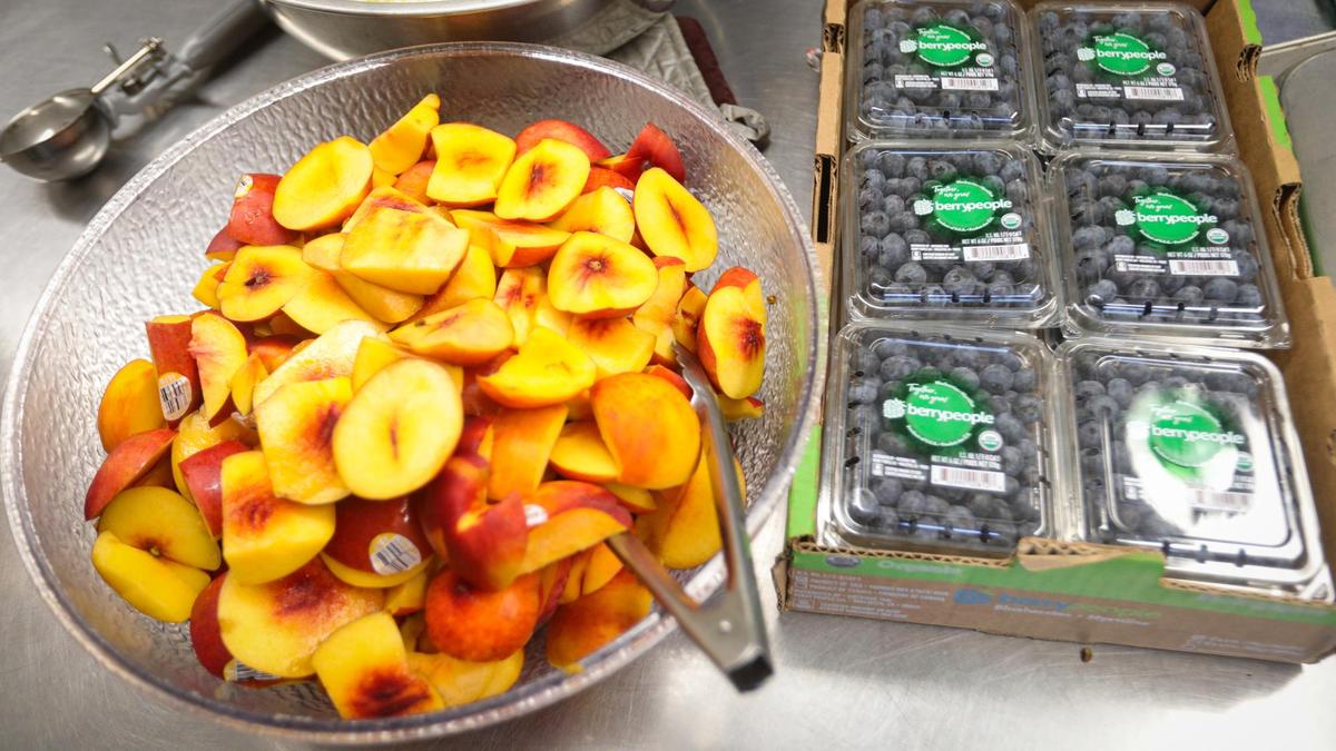 Peaches and blueberries are prepared for lunch at Lillian Larsen Elementary School in San Miguel seen here on Aug. 22, 2022.