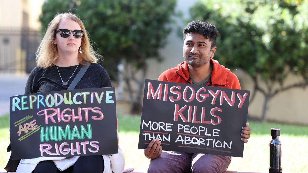 Protesters hold signs outside the courthouse in San Luis Obispo on Tuesday evening to oppose the Supreme Court’s draft decision to overturn Roe v. Wade.