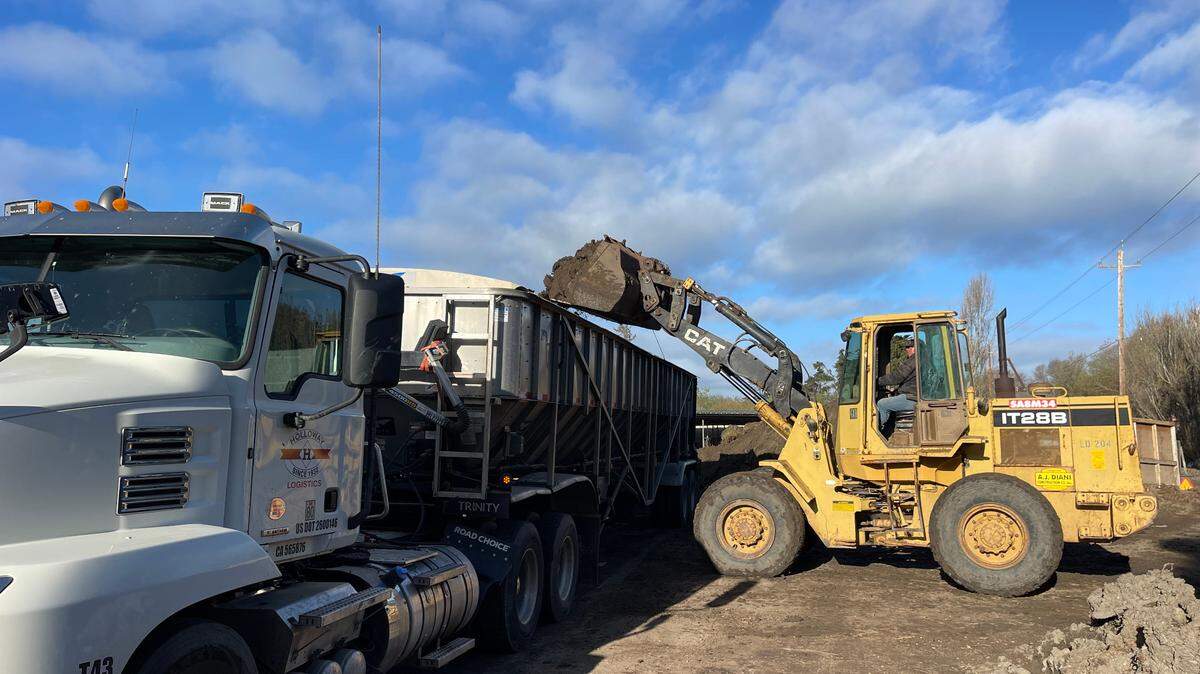 Volunteers clean up debris from the Cardoza farm in Oceano on Saturday, Feb. 11, 2023.