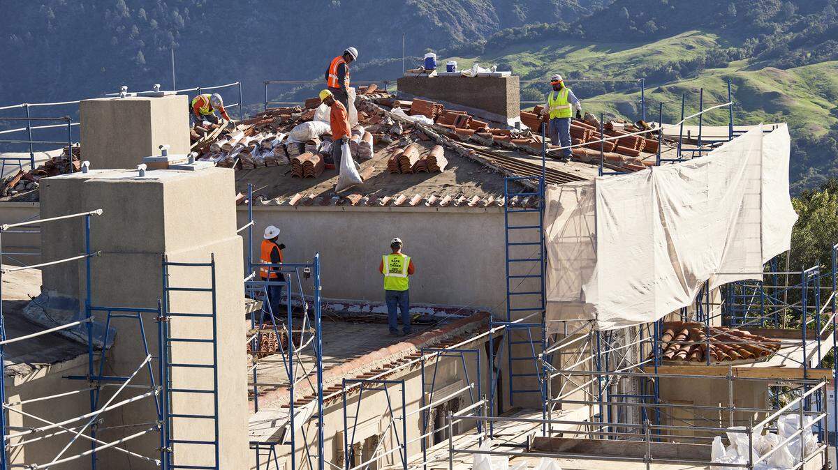 Crews work to replace tiles and make other repairs on the roof of Hearst Castle. 
