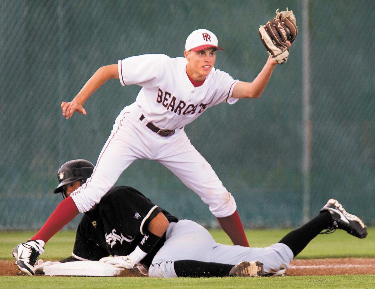 Local umpires and schools have ended a negotiation over pay. Paso Robles High third baseman T.J. Durfee looks to the umpire for the call after tagging out San Luis Obispo’s Marco Murillo on a close play during the third inning of Thursday’s PAC 7 baseball game at Paso Robles in 2012.