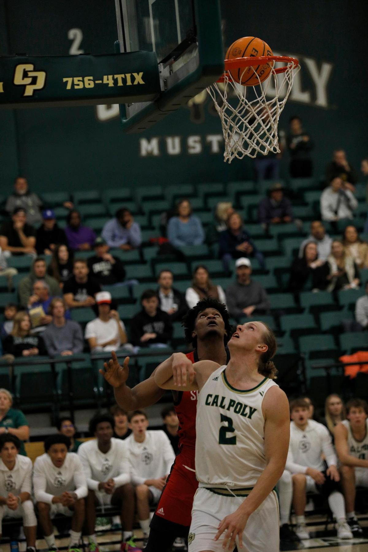 Cal Poly’s Mac Riniker goes for a basket while Seattle University’s Matthew-Alexander Moncrieffe defends. Cal Poly beat Seattle University 75-71 in a college basketball game at Mott Athletics Center on Nov. 14, 2024.