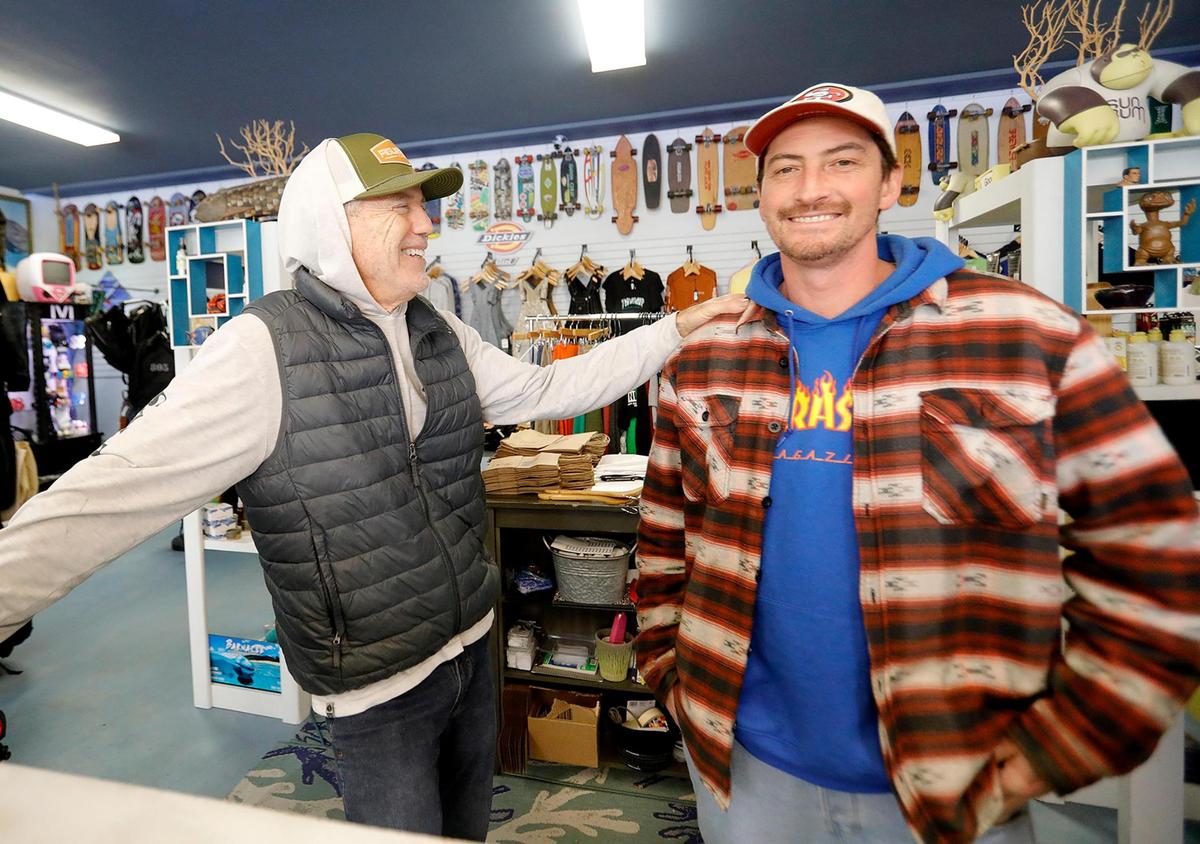 805 Boardshop in Atascadero has moved to a new, larger location on El Camino Real, where it sells skateboards, surf boards, clothing, wetsuits and more. Owner Kevin Campion, left, talks with store manager Tristan Ehrheart.