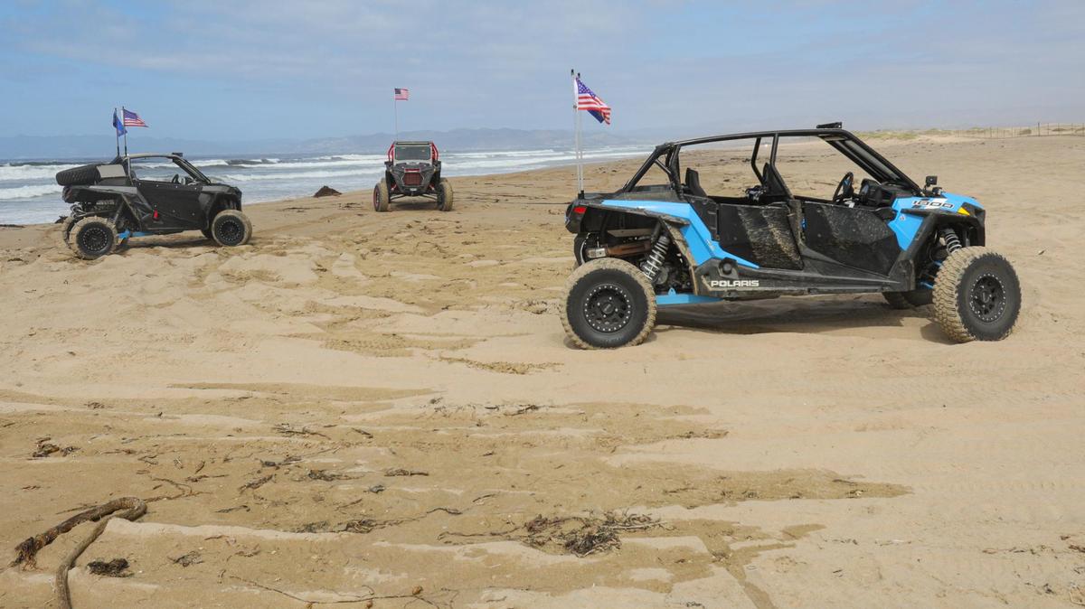 Off-highway vehicles are parked south of mile marker 8 at Oceano Dunes State Vehicular Recreation Area on Oct. 7, 2021.