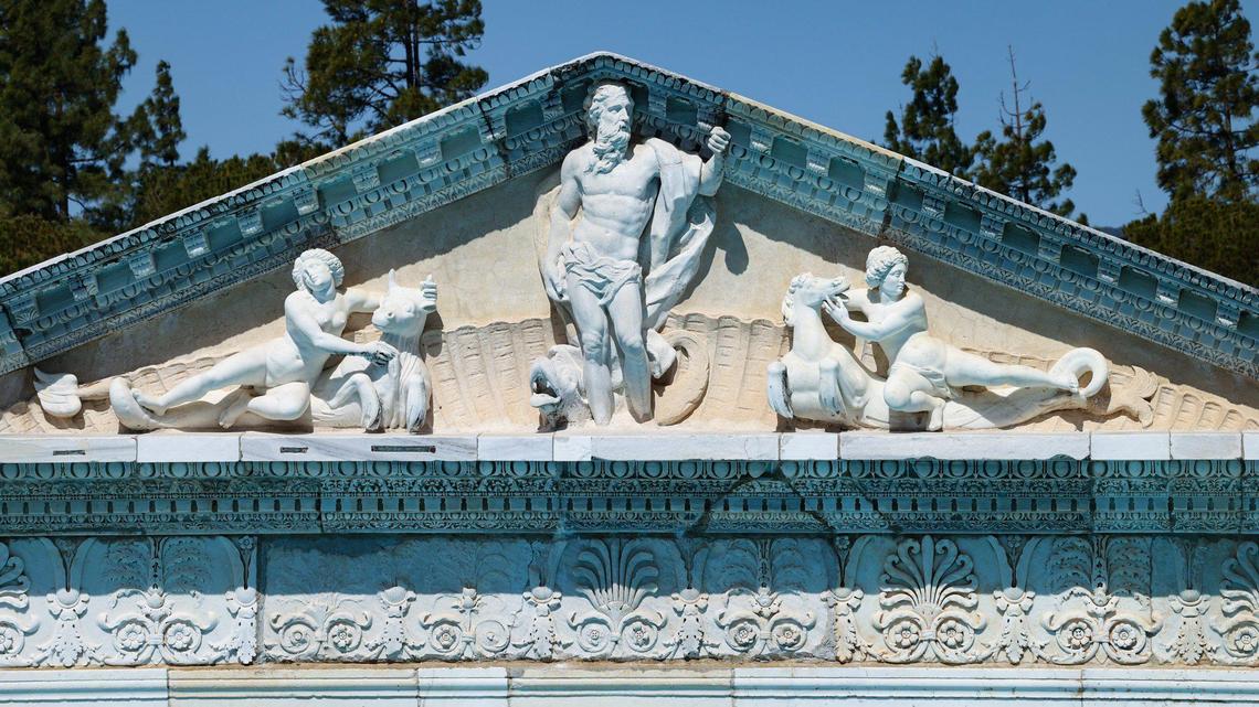 The Neptune Pool temple Pediment features Italian Renaissance marble sculptures of Neptune flanked by the Nereids. Architect Julia Morgan artfully engineered antiques into the new construction at Hearst Castle.