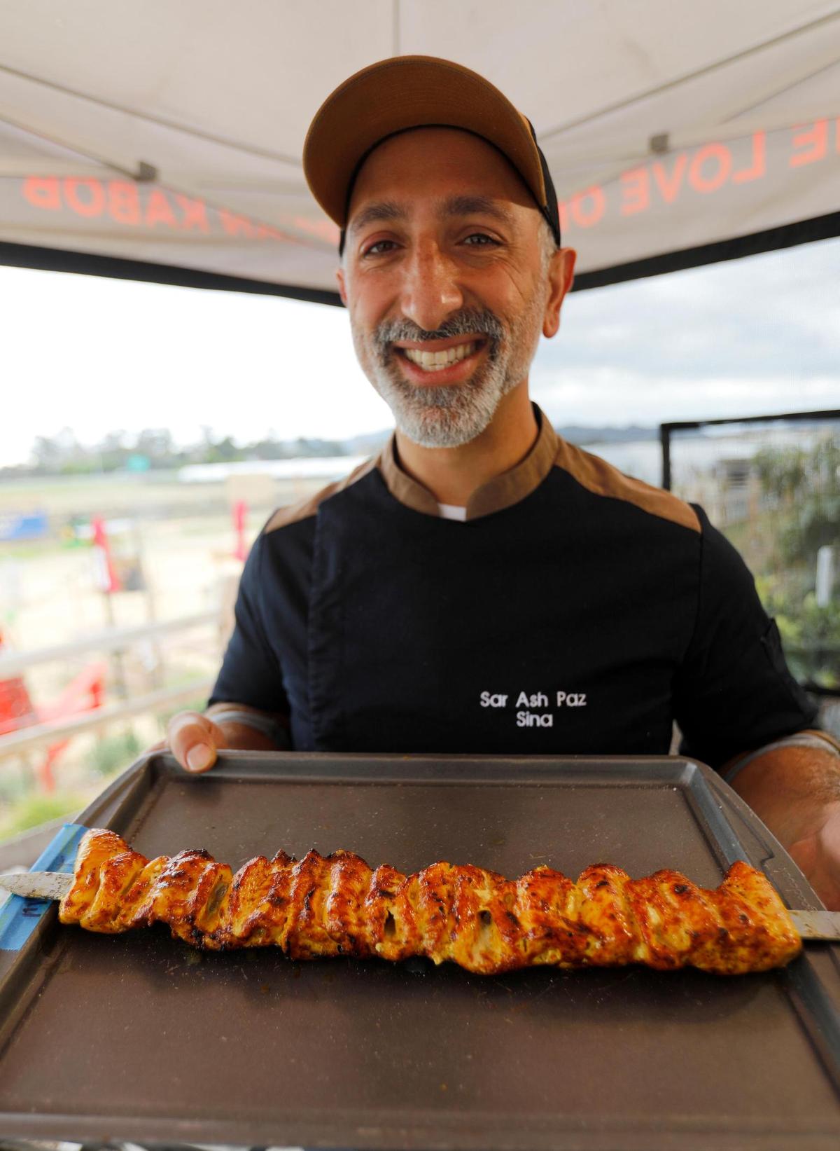 Shekamoo owner Sina Shakerian shows off a chicken hot off the barbecue grill. Shekamoo Grill celebrated its grand opening at SLO Ranch Farms & Marketplace. The new restaurant is one of the first Persian cuisine spots in San Luis Obispo.