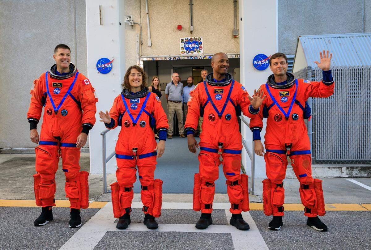 Artemis II crew members (from left) CSA (Canadian Space Agency) astronaut Jeremy Hansen and NASA astronauts Christina Koch, Victor Glover and Reid Wiseman walk out of Astronaut Crew Quarters inside the Neil Armstrong Operations and Checkout Building to the Artemis crew transportation vehicles prior to traveling to Launch Pad 39B as part of an integrated ground systems test at Kennedy Space Center in Florida on Wednesday, Sept. 20, to test the crew timeline for launch day.