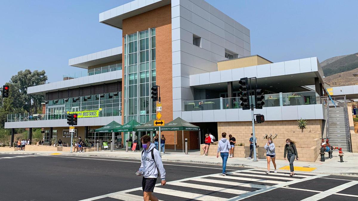 Masked students walk outside Cal Poly’s new Vista Grande Dining Complex in September 2020. The San Luis Obispo university turned away 15,660 students with grade-point averages of 4.0 or higher who were seeking to enroll at the university for fall 2021.