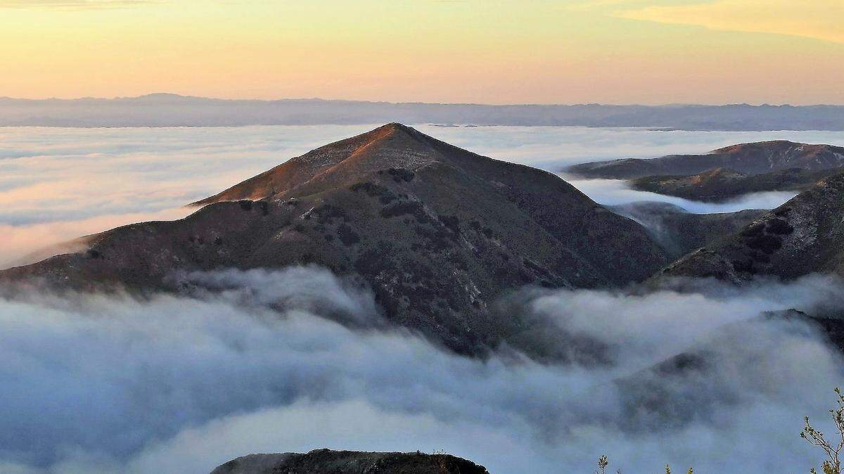 Marine stratus clouds tumble in along the Central Coast.