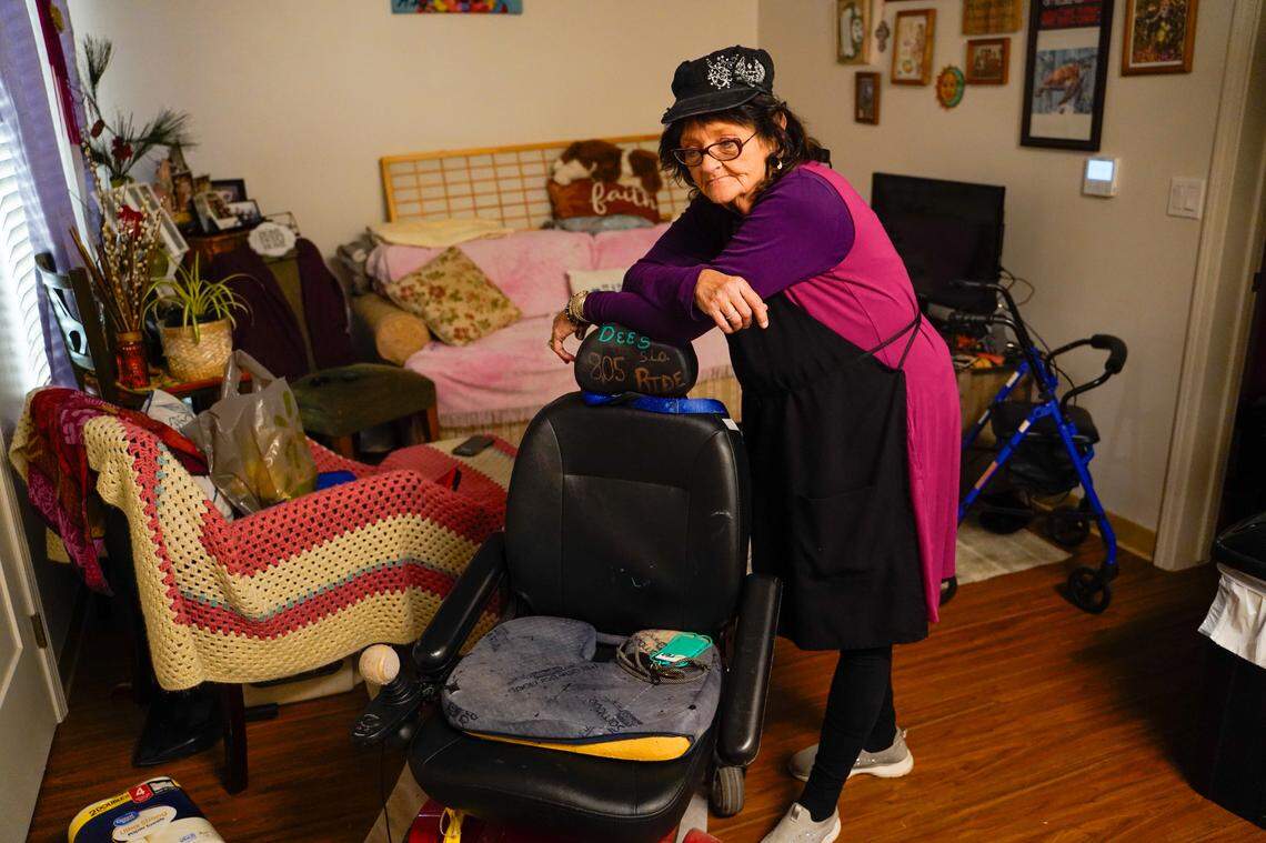 Darlene Maphis, 66, stands with her wheelchair in her apartment at the Templeton Place II affordable housing community on Thursday, Sept. 19, 2024. Maphis said even with affordable housing and some of her expenses covered, she still struggles with San Luis Obispo County’s high cost of living.