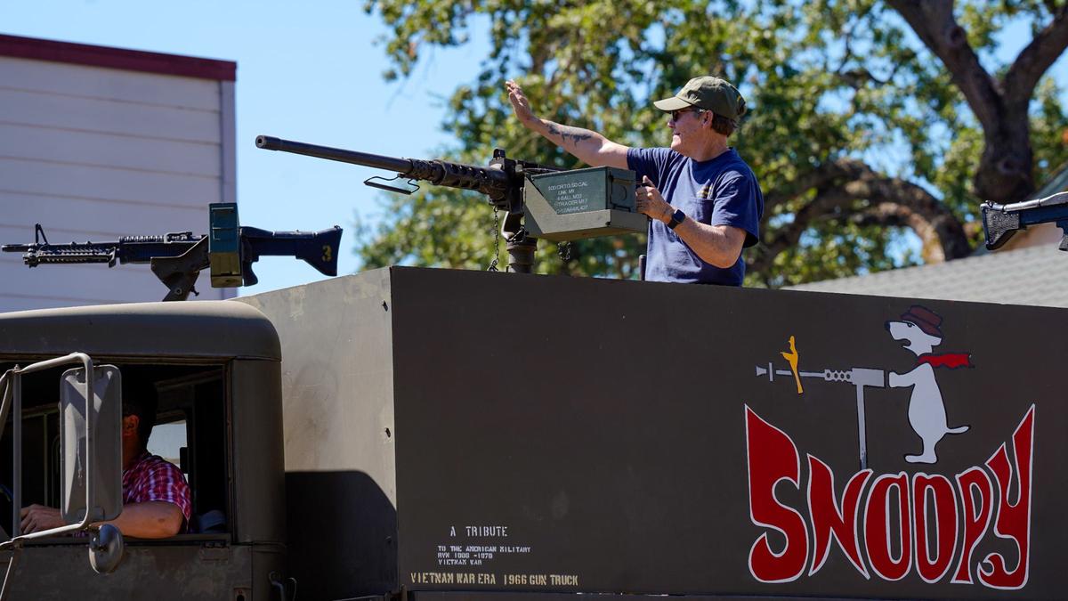 A Vietnam War-era combat vehicle driven by the Estrella Warbirds Museum cruises down the street in the Templeton Fourth of July Parade Thursday, July 4, 2024. The parade featured dozens of floats and acts, including classic cars, marching bands and appearances by local law enforcement and fire services.