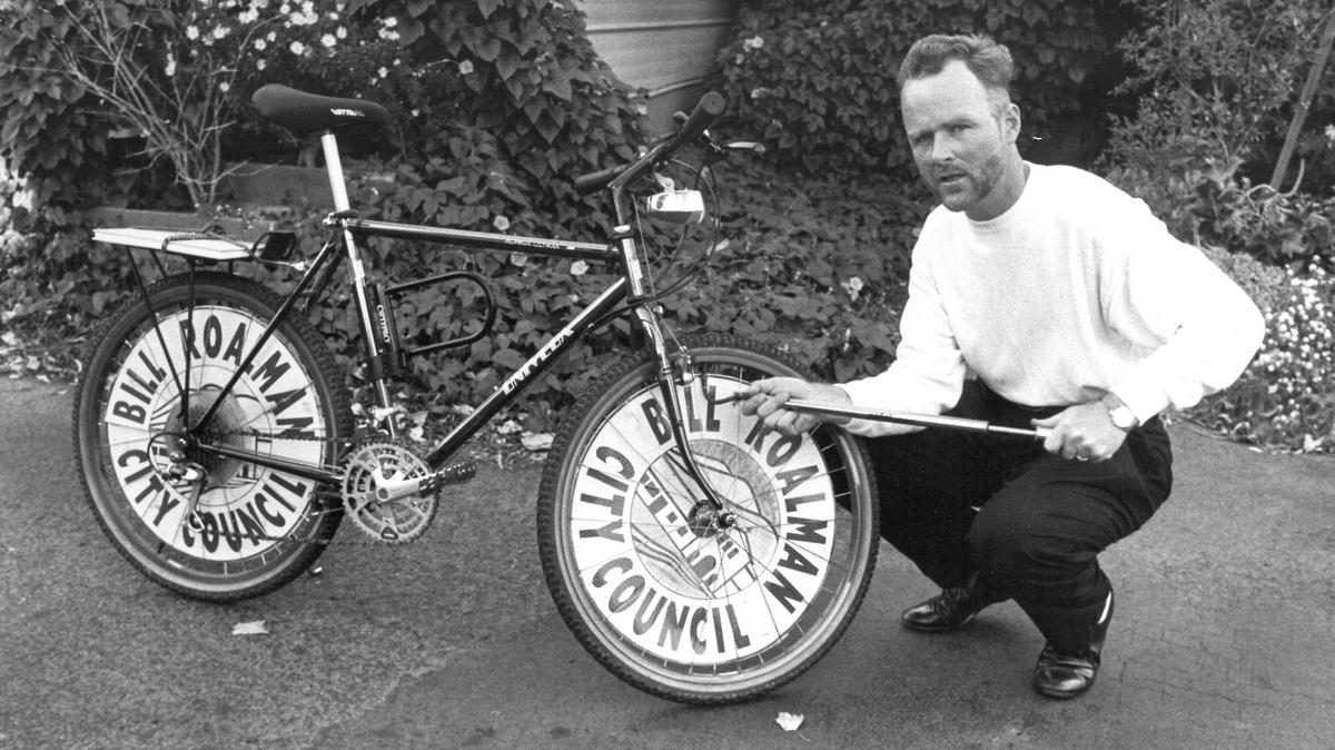 Bill Roalman pumps up tire of the bike that he bought at a police auction and rode nearly every day to work. The environmental planner was elected to San Luis Obispo city council in the late 1980s and 1990s.