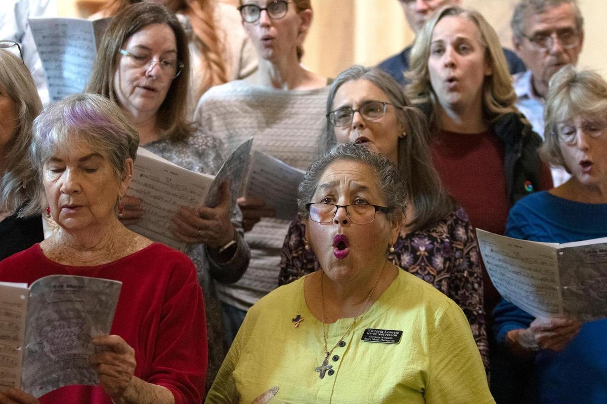 Victoria Lowrie, center, sings during the memorial event for Gary Lamprecht at the Mission San Luis Obispo on Feb. 24, 2024.