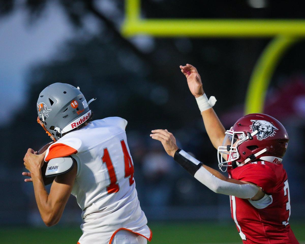 Mason Degnan catches a pass as Cleo Mercdo defends. Atascadero beat Paso Robles 28-14 at War Memorial Stadium on Sept., 1, 2023.