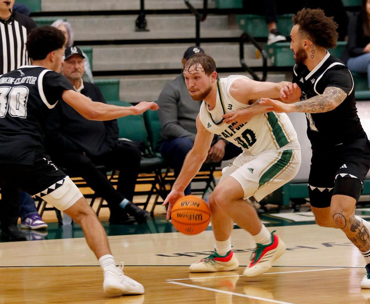 Isaac Jessup defends the ball against the Rainbow Warriors’ offense. Cal Poly beat Hawaii 79-63 in a men’s basketball game at Mott Athletic Center in San Luis Obispo on Thursday, Feb. 6, 2025.