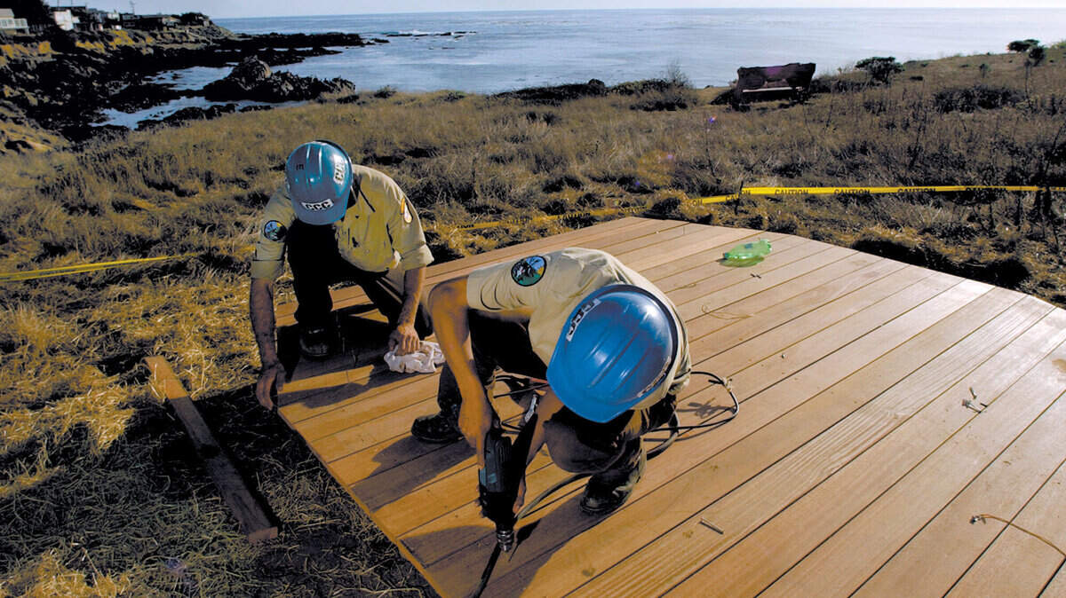 In November 2000, the spectacular 417-acre East West Ranch in Cambria was purchased for $11.1 million, a sale that meant it will be preserved as a park. The purchase capped a two-year effort headed by the American Land Conservancy and community leaders. In 2005, the California Conservation Corp built a new boardwalk along the cliffs at  the ranch. Michael Maciugec and Jose Luis Castaneda bolted down boards at the end of the boardwalk. Photo: Laura Dickinson  11-17-05