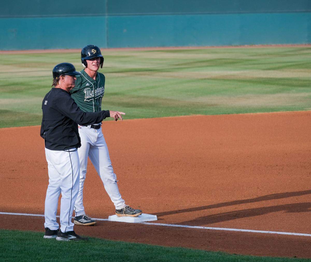 Head Coach Larry Lee talks with Ryan Tayman at third base during Saturday’s Big West Championship game against UC San Diego. Tayman had two hits in the loss.