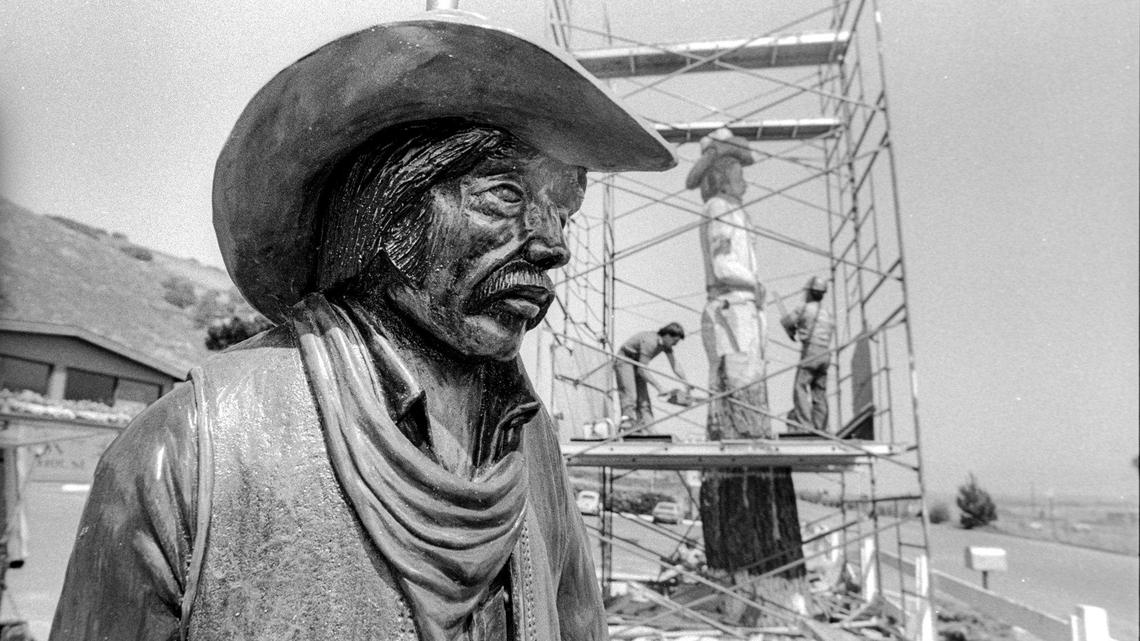 A sculptor uses a carved lamp, left, as a model for Clint the rugged cowpoke at McLintocks Saloon and Dining House in Pismo Beach. A dead Monterey pine was carved into the landmark Clint the cowboy in June 1983.